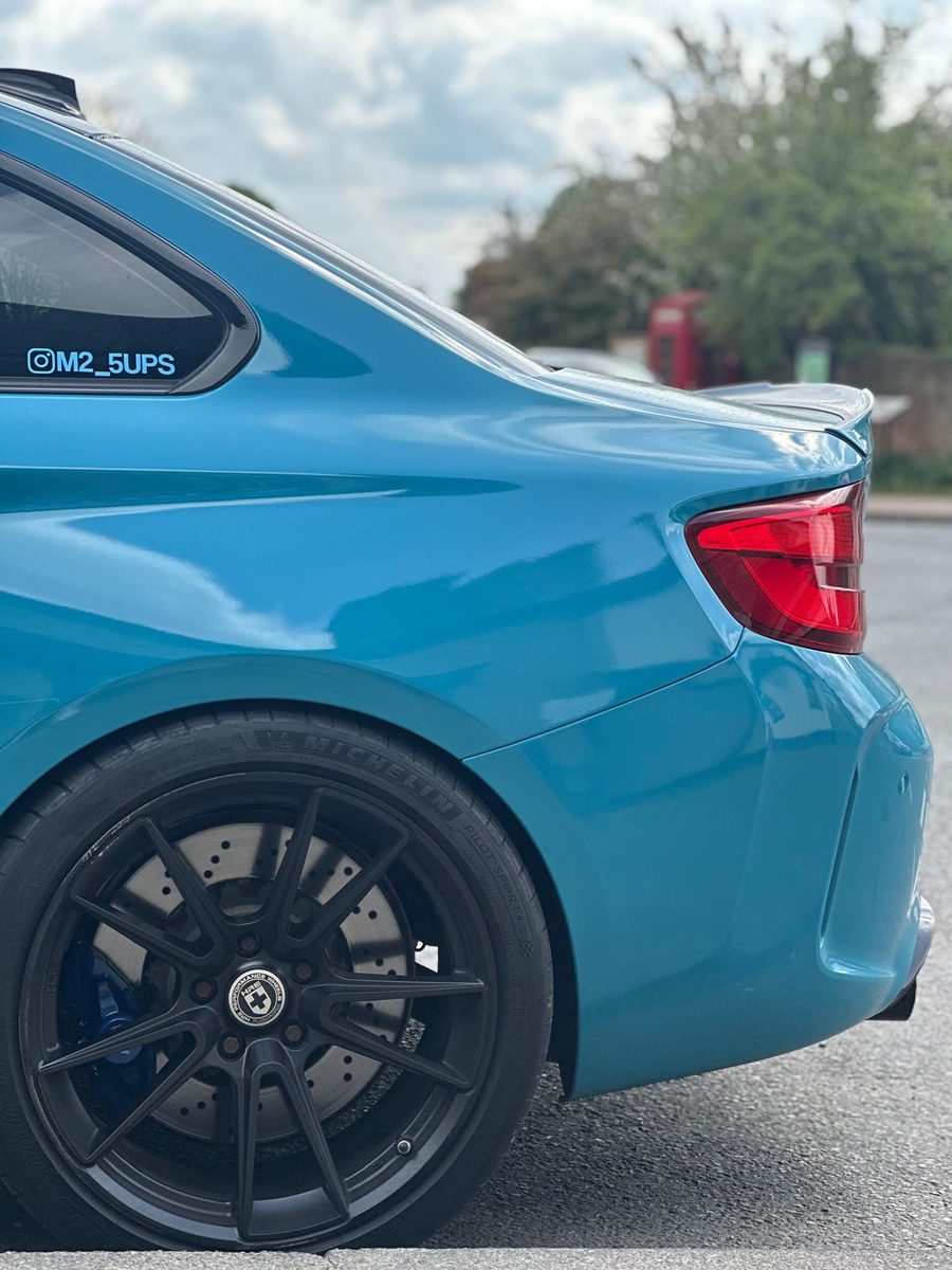 Rear wheel arch and black HRE wheel of the M2